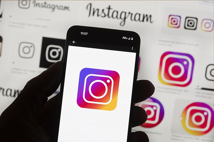 The Instagram logo is seen on a cell phone, Friday, Oct. 14, 2022, in Boston. Google, Facebook, TikTok and other Big Tech companies operating in Europe are facing one of the most far-reaching efforts to clean up what people encounter online. (Michael Dwyer/AP, File)