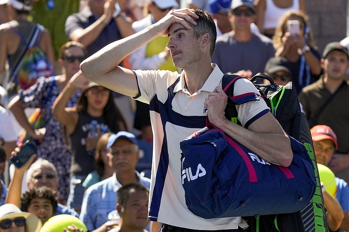 John Isner, of the United States, reacts after losing to Michael Mmoh, of the United States, during the second round of the U.S. Open championships, Thursday, Aug. 31, 2023, in New York. (John Minchillo/AP)
