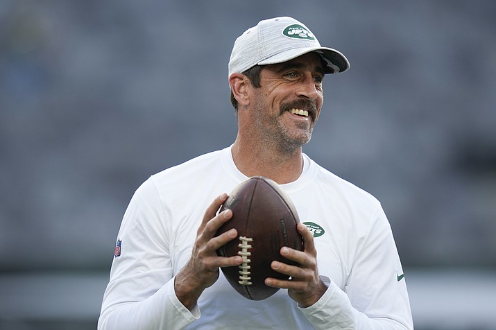 New York Jets quarterback Aaron Rodgers walks on the field during warm-ups before a game against the Tampa Bay Buccaneers, Saturday, Aug. 19, 2023, in East Rutherford, N.J. He’ll become a folk hero if he can lead the Jets to a Super Bowl for the first time since Broadway Joe Namath.(Seth Wenig/AP, File)