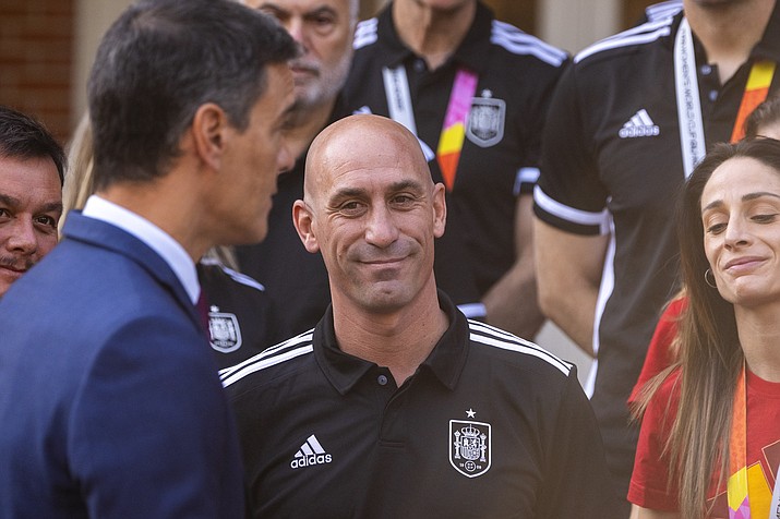 President of Spain's soccer federation Luis Rubiales, stands with Spain's Women's World Cup soccer team after being received by Spain's Prime Minister Pedro Sanchez, left, at La Moncloa Palace in Madrid, Spain, Tuesday, Aug. 22, 2023. The kiss by Luis Rubiales has unleashed a storm of fury over gender equality that almost marred the unprecedented victory but now looks set to go down as a milestone in both Spanish soccer history but also in women's rights.(Manu Fernandez/AP, file)