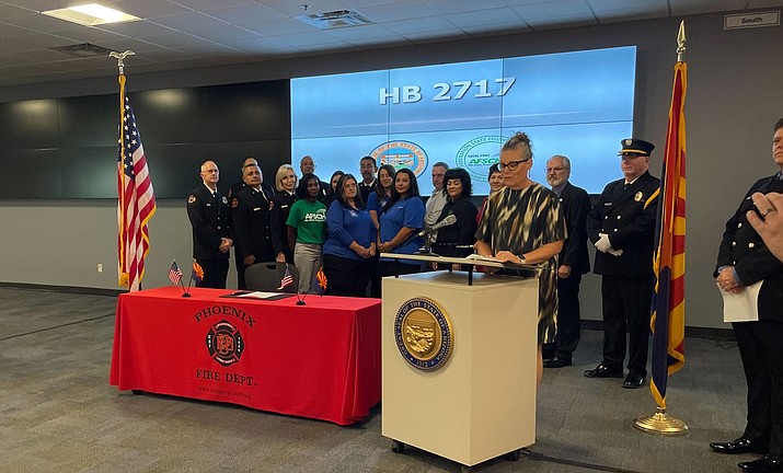 Arizona Gov. Katie Hobbs celebrates a bill offering trauma therapy to 911 dispatchers on Aug.23, 2023, at the Phoenix Fire Department’s 911 regional dispatch center. (Cameron Arcand/Cronkite News)