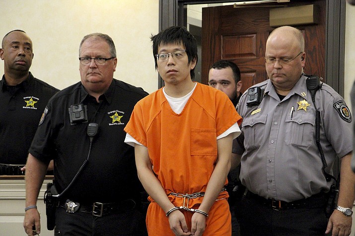 Tailei Qi, the graduate student suspected in the fatal shooting of a University of North Carolina at Chapel Hill faculty member, center, makes his first appearance at the Orange County Courthouse in Hillsborough, N.C., Tuesday, Aug. 29, 2023. Qi has been charged by the UNC Police Department with first-degree murder and possession of a weapon on educational property, both felony charges. (Hannah Schoenbaum/AP)