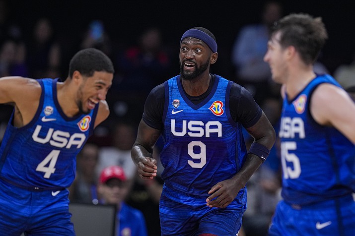 U.S. forward Bobby Portis Jr. (9) celebrates between teammates Tyrese Haliburton (4) and Austin Reaves (15) during the second half of a FIBA World Cup group C match against Greece in Manila, Philippines Monday, Aug. 28, 2023. (Michael Conroy/AP)